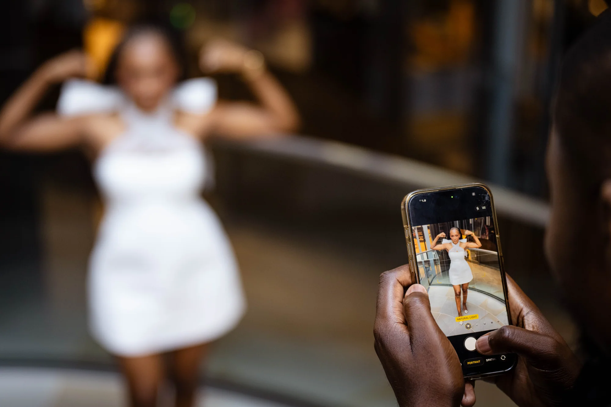 A photograph of Kennedy and Didimalang being captured on a phone