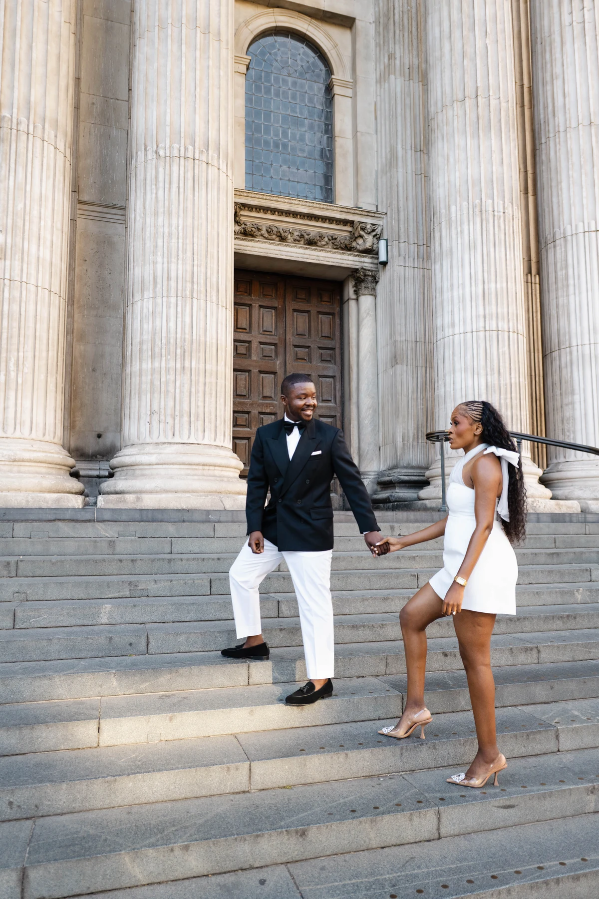 Kennedy and Didimalang walking down the cathedral steps